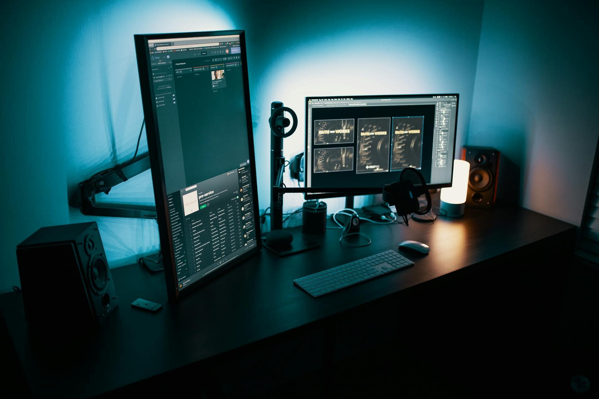 Dual monitor tech workspace with editing and communication tools.